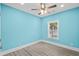 Simple bedroom with light blue walls, wood-look floors, and a window at 6001-N37 S Kings Hwy., Myrtle Beach, SC 29575