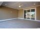 Spacious covered patio with tile flooring, ceiling fan, and sliding glass doors at 1100 Maccoa Dr., Conway, SC 29526
