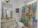 Bathroom with shower/tub combo, sink, and patterned shower curtain at 6 Cottage Dr., Murrells Inlet, SC 29576