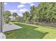 Fenced backyard with lush lawn and canal view at 6 Cottage Dr., Murrells Inlet, SC 29576
