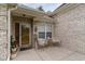 Brick front porch with seating area and decorative planters at 355 Foxtail Dr., Longs, SC 29568