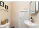 Small bathroom with pedestal sink, toilet, and mirrored medicine cabinet at 355 Foxtail Dr., Longs, SC 29568