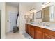 Elegant bathroom with double vanity, tile floor, and large mirror at 355 Foxtail Dr., Longs, SC 29568