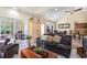 Open living space with leather sofas and views into the kitchen and sunroom at 355 Foxtail Dr., Longs, SC 29568