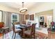 Elegant dining room with a glass-top table and hardwood floors at 355 Foxtail Dr., Longs, SC 29568