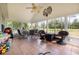 Relaxing screened porch, ceiling fan, wicker furniture, and backyard view at 6458 Sweet Gum Trail, Myrtle Beach, SC 29588
