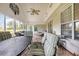 Large screened porch with seating area and view of the backyard at 6458 Sweet Gum Trail, Myrtle Beach, SC 29588