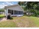 House exterior with screened porch, landscaping, and a grill at 6458 Sweet Gum Trail, Myrtle Beach, SC 29588