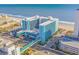 Aerial view of a large teal building near the beach with parking and a walkway at 1501 S Ocean Blvd. # 1235, Myrtle Beach, SC 29577