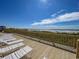 Ocean view from beachfront deck with lounge chairs at 6108 N Ocean Blvd. N, North Myrtle Beach, SC 29582