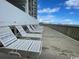 Oceanfront building with relaxing lounge chairs on a wooden deck at 6108 N Ocean Blvd. N, North Myrtle Beach, SC 29582