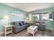 Beachy living room with gray sofas, white coffee table, and ocean-themed art at 202 75Th Ave N # 5706/5707, Myrtle Beach, SC 29572