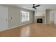 Living room featuring hardwood floors, fireplace, and access to other rooms at 3758 Loblolly Ave., Little River, SC 29566