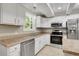 Bright kitchen featuring white cabinets and stainless steel appliances at 3758 Loblolly Ave., Little River, SC 29566
