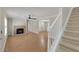 Bright living room with hardwood floors, fireplace, and staircase at 3758 Loblolly Ave., Little River, SC 29566