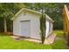 White storage shed with double doors and window at 3758 Loblolly Ave., Little River, SC 29566