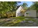 Home with detached garage and deck in wooded setting at 3758 Loblolly Ave., Little River, SC 29566