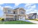 Two-story house with beige siding, stone accents, and a two-car garage at 357 Glacier Way, Conway, SC 29526