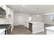 Modern kitchen with white cabinets, quartz countertops, and stainless steel appliances at 357 Glacier Way, Conway, SC 29526