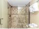 Large walk-in shower with tiled walls and built-in seat at 201 74Th Ave. N # 1002, Myrtle Beach, SC 29572