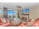 Living room with fireplace, ocean view, and comfortable seating at 201 74Th Ave. N # 1002, Myrtle Beach, SC 29572