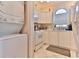 Well-equipped kitchen with white cabinets and a stackable washer/dryer at 3412 Westminster Dr., Myrtle Beach, SC 29588