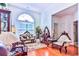 Bright living room with hardwood floors, antique furniture and a large arched window at 3412 Westminster Dr., Myrtle Beach, SC 29588
