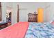 Main bedroom with a post bed, coral colored quilt, and built-in wardrobe at 3412 Westminster Dr., Myrtle Beach, SC 29588