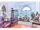 Elegant living room featuring hardwood floors, antique furniture, and a large arched window at 3412 Westminster Dr., Myrtle Beach, SC 29588