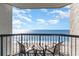 Balcony with chairs and a table overlooking the ocean at 2401 Ocean Blvd. S # 1062, Myrtle Beach, SC 29577