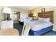 Two beds in a well-lit bedroom with a small table at 2401 Ocean Blvd. S # 1062, Myrtle Beach, SC 29577