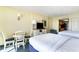 Bedroom with two beds, dresser, and small dining table at 2401 Ocean Blvd. S # 1062, Myrtle Beach, SC 29577