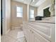 Double vanity bathroom with a large mirror and tile floors at 758 Parker Dr., Pawleys Island, SC 29585