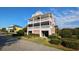 Three-story beach house with multiple balconies and landscaping at 758 Parker Dr., Pawleys Island, SC 29585
