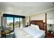 King-size bed, dresser, and balcony with ocean view in a hotel room at 1200 N Ocean Blvd. # 308, Myrtle Beach, SC 29577