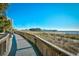 Walkway to the beach with ocean views and a pier in the distance at 1200 N Ocean Blvd. # 308, Myrtle Beach, SC 29577