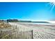 Sandy beach with ocean view and pier in the background at 1200 N Ocean Blvd. # 308, Myrtle Beach, SC 29577