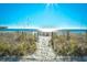 Sandy beach path with tall grasses leading to the ocean at 1200 N Ocean Blvd. # 308, Myrtle Beach, SC 29577