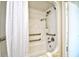 Accessible shower with grab bars and white curtain at 1200 N Ocean Blvd. # 308, Myrtle Beach, SC 29577