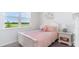 Quaint bedroom with a white bed frame, pink bedding, and a window seat at 543 Duvall St., Longs, SC 29568