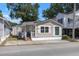 Tan colored house with white trim, front porch, and small yard at 6001 - 1824 S Kings Hwy., Myrtle Beach, SC 29575