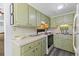 Galley kitchen with light green cabinets at 6001 - 1824 S Kings Hwy., Myrtle Beach, SC 29575