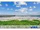 Beachfront property with ocean views and a pier in the distance at 116 South Waccamaw Dr. # 204, Garden City Beach, SC 29576