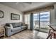 Living room with ocean view and sliding glass doors at 116 South Waccamaw Dr. # 204, Garden City Beach, SC 29576