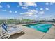 Inviting swimming pool with ample lounge chairs at 116 South Waccamaw Dr. # 204, Garden City Beach, SC 29576