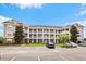 Three-story building exterior with parking and landscaping at 124 South Shore Blvd. # 303, Longs, SC 29568