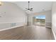 Spacious living room with hardwood floors, high ceilings, and sliding glass doors leading to a balcony at 124 South Shore Blvd. # 303, Longs, SC 29568