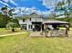 Home's rear exterior showcasing patio, hot tub, and gazebo at 6005 Saint Peters Church Rd., Myrtle Beach, SC 29588