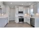 Modern kitchen with white cabinets, stainless steel appliances and a farmhouse sink at 181 Azure Loop, Myrtle Beach, SC 29588