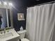 Modern bathroom with white vanity, dark walls, and a shower/tub combo at 1100 Possum Trot Rd. # F-224, North Myrtle Beach, SC 29582